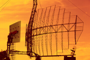 Large radar installation against a bright sky