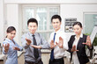 © eastfenceimage - Group of young business people in Kung Fu pose