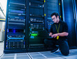 © Erik Isakson - Employee working on server rack in data center