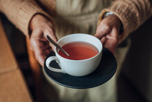 Senior Woman's Hands Holding Cup Of Tea