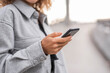 © MaxwellArt Photography/Westend61 - Young woman using smart phone while standing on bridge in city