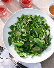 Plates Of Salad With Peas And Baby Spinach