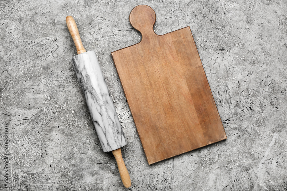 Marble rolling pin and board on grunge background