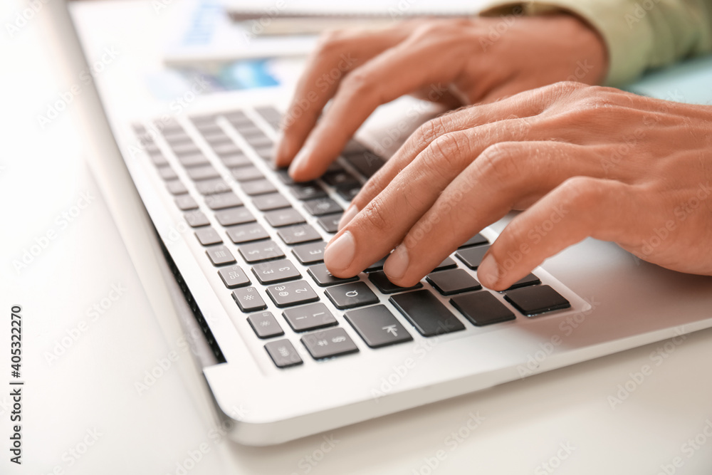 Young man with laptop at home, closeup