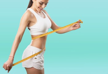 Wall Mural - Weight loss concept. Woman with measuring tape