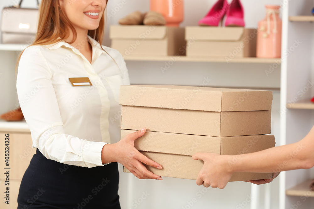 Woman buying shoes in modern store