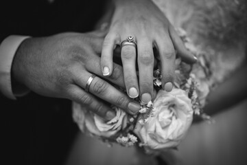 Sticker - Black and white shot of the hands of a bride and groom showing their rings - wedding, anniversary