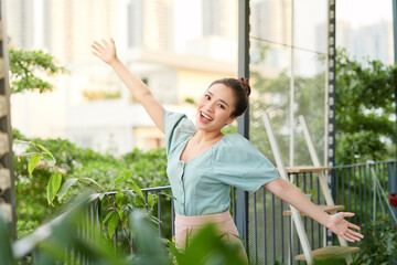 Energy young Asian woman posing on the balcony.