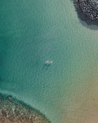 Aerial shot of two boats floating on light blue water