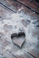 Sticker - Heart shaped cookie cutter on the kitchen table and flour. Valentine's Day concept. Vertical Image