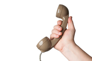 Caucasian man holds the handset of an old vintage telephone on a white background