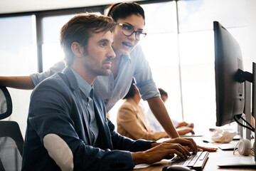 Group of young business people working and communicating at the office