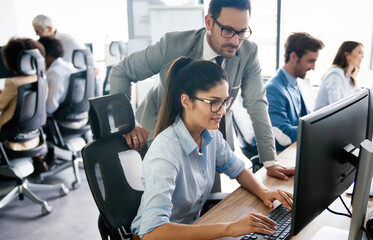 Group of young business people working and communicating at the office