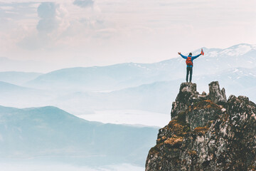 Wall Mural - Man climber on mountain cliff summit traveling hike in Norway adventure vacations outdoor extreme activity healthy lifestyle traveler success raised hands Husfjellet peak