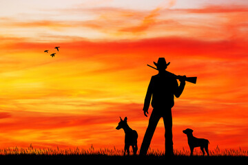 Wall Mural - hunter with dogs at sunset