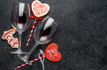 valentine's day celebration concept .glasses with wine and heart shaped cookies on stone background with copy space for your text