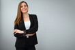© Yuriy Shevtsov - Smiling business woman wearing black suit standing with crossed arms.