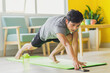 © Timeimage - Asian man doing exercise at home