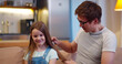 © TommyStockProject - Caring smiling father brushing adorable preschool daughter hair