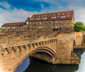 Wall Mural - A view across the Old Bridge at Riverside, Godmanchester, UK toward the Mill buildings in springtime