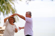 © sutthichai - Asian senior love couple travel relaxing on the beach. Retirement and recreation on summer holiday.