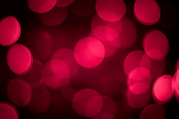 Wall Mural - Bright pink defocus lights on a black background. Abstract bokeh background. Valentine's Day.