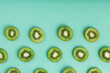 The patterns of the slices of kiwi fruit on green background as a continuous background.