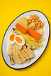 boiled cod fish with boiled vegetables and egg on white dish