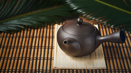 Wall Mural - Kyusu, teapot used in making japanese green tea on wooden background banner, copy space. Wabi sabi concept, selective focus. Minimalism. Vintage effect.