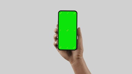 Wall Mural - smartphone blank in hand enters the camera frame - animation best quality, no blurs, green screen an
