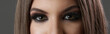 © triocean - Close up of woman eyes with smokey eyes makeup and fake lashes, studio shot, looking to camera.