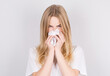 © MP Studio - Studio portrait of cute unhealthy caucasian woman with paper napkin sneezing due to allergy, flu or cold