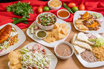 Wall Mural - Authentic Mexican food. Carnitas rice bowl, chicken flautas, cheese quesadilla, hand made corn tortilla chips. 