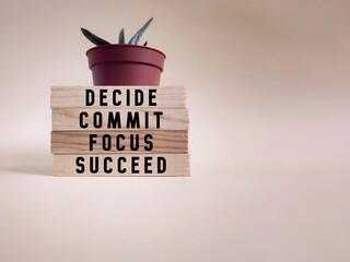 Wall Mural - Inspirational and motivational concept - Decide commit focus succeed text on wooden blocks background. Stock photo.
