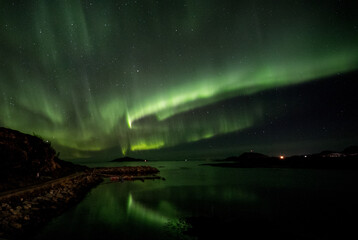 reflections of aurora over water