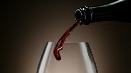 Pouring red wine into wine glass