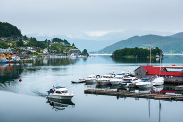 Wall Mural - Cloudy summer view of Hardangerfjord and Norheimsund village, Norway, Europe. Landscape photography