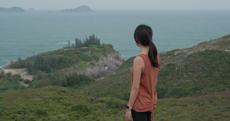 Poster - Woman look at the sea from the top of the mountain