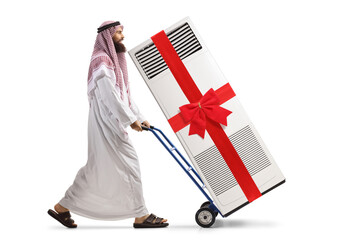 Wall Mural - Saudi arab man pushing a hand-truck with a self standing ac unit tied with a bow