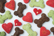 Many Different Dog Biscuits Of Hearts And Bones On A White Background 
