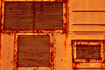 Canvas Print - Metal air grilles. An old rusty sheet of metal. The texture of sheet metal, the grunge style. An empty orange background.