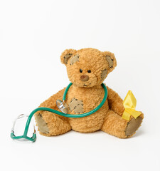 Wall Mural - brown teddy bear with a patch,  silk yellow ribbon in the shape of a loop