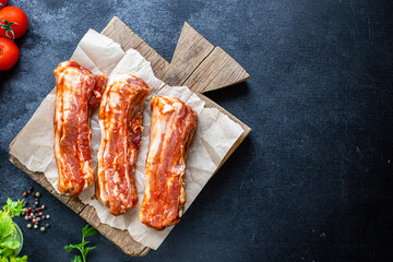 Wall Mural - ribs raw bbq marinated barbecue sauce grill pork meat on the table meal snack outdoor top view copy space for text food background rustic image