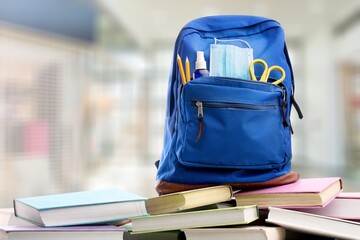 Poster - Classic school backpack with colorful school supplies and books on desk.