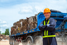 Portrait Of Smiling Engineer Standing Against Junkyard Truck