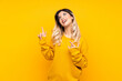 © luismolinero - Teenager girl isolated on yellow background pointing with the index finger a great idea