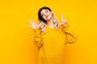 © luismolinero - Teenager girl isolated on yellow background counting seven with fingers