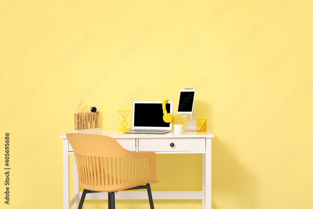 Stylish workplace with modern gadgets against color wall in room - obrazy, fototapety, plakaty 