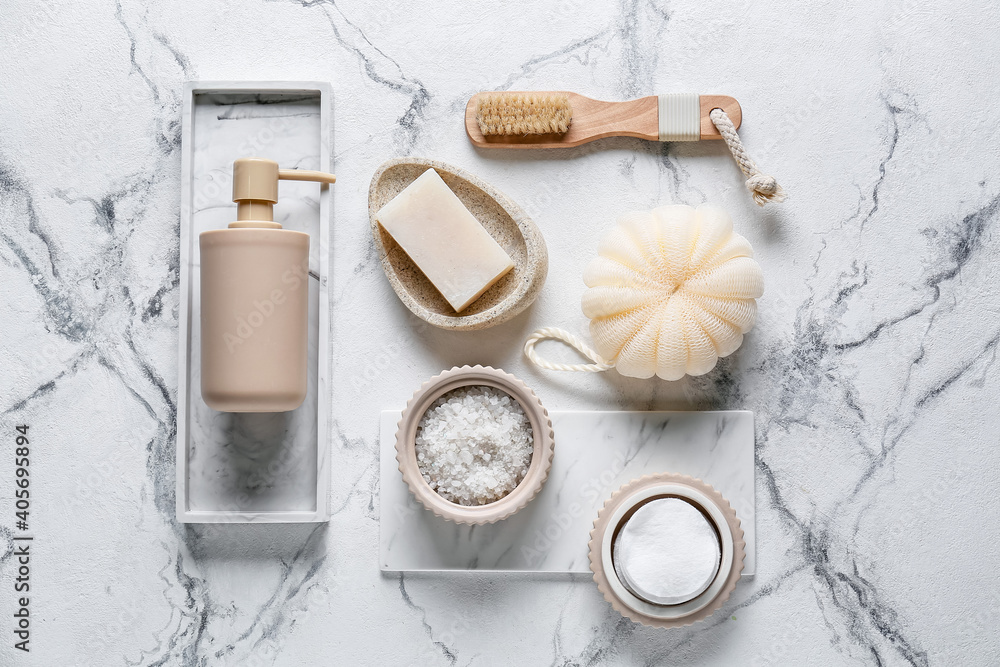 Composition with bath accessories and cosmetics on light background