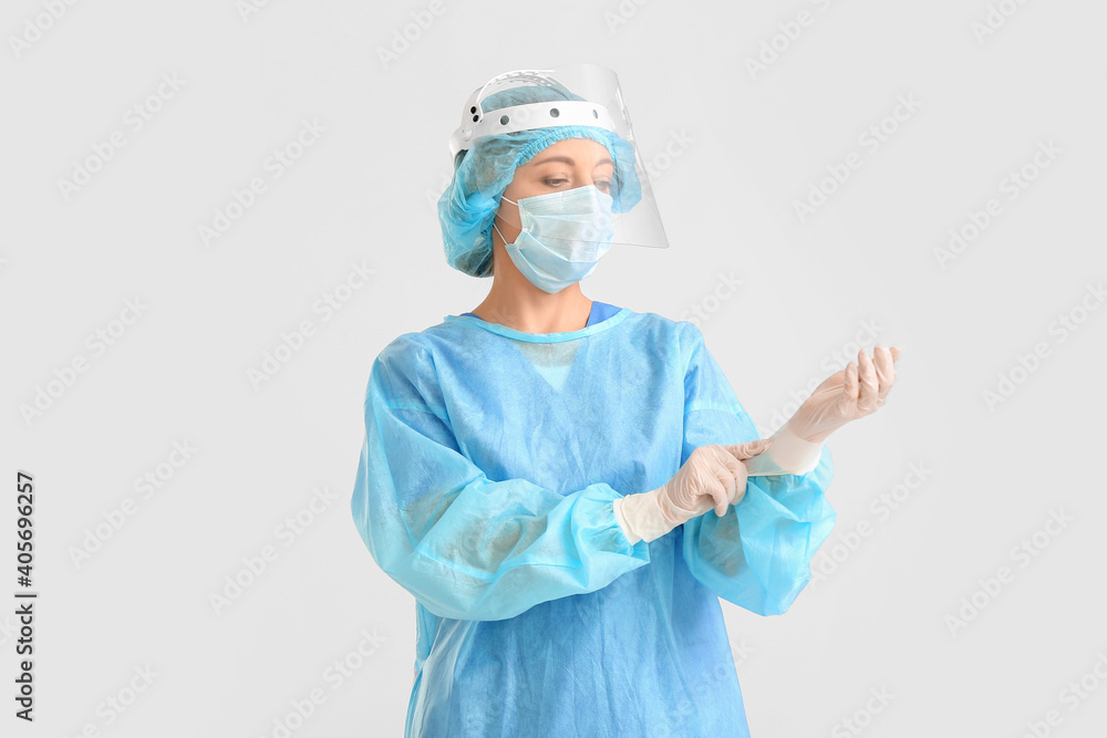 Portrait of female surgeon on light background
